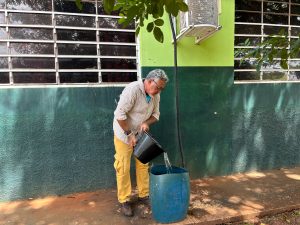 professor coletando a água do ar condicionado.